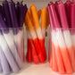 Taper candle in hues of pink and orange