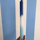 Taper candle in hues of blue.