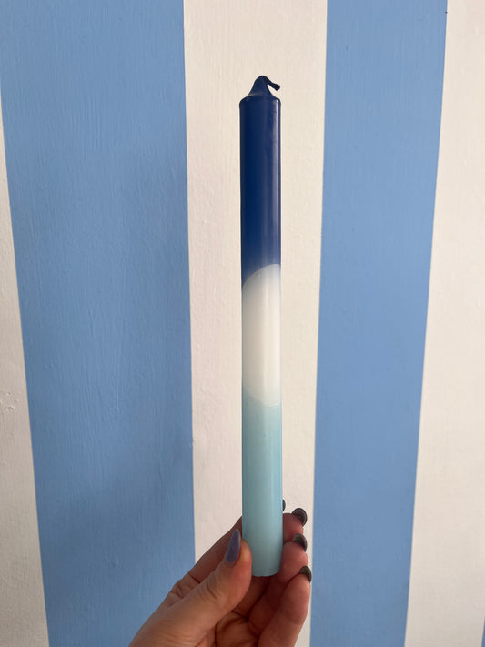 Taper candle in hues of blue.